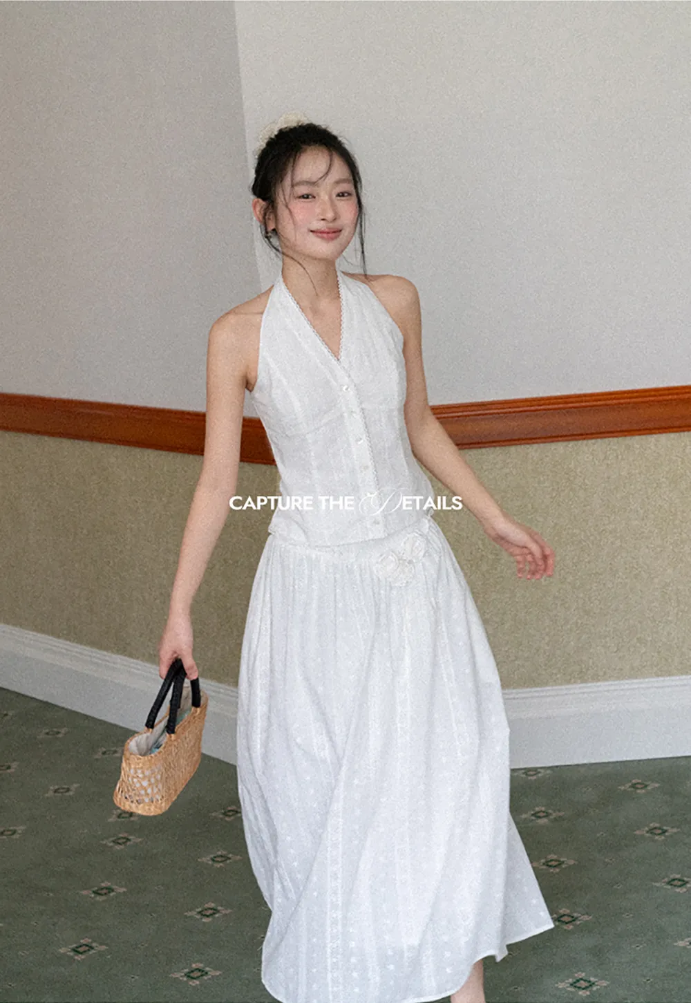 Halter neck sleeveless top with buttons and pleated skirt