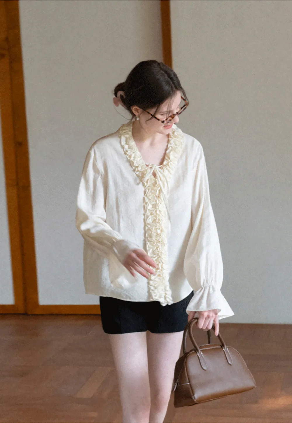 Long sleeve shirt with ruffled neckline and gathered cuffs