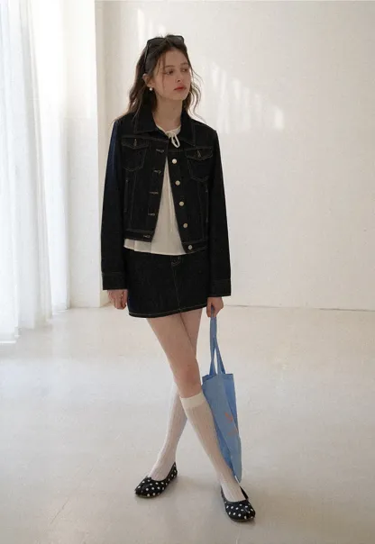 A-line denim skirt with front pocket design and adjustable waistband.