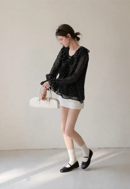 Sheer polka dot blouse with ruffled neckline and long sleeves