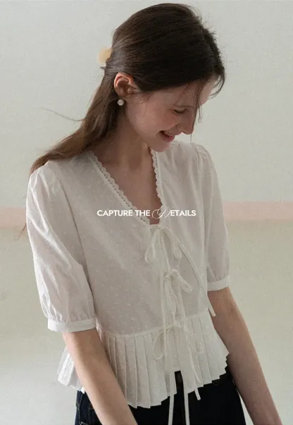 V neck short sleeve blouse with pleated hem and tie front