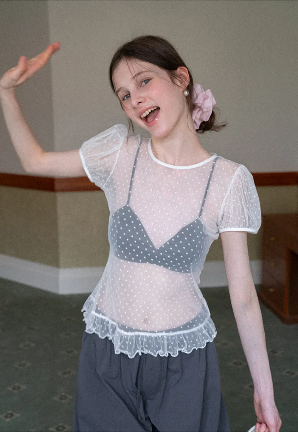 Sheer polka dot top with ruffled hem and puff sleeves