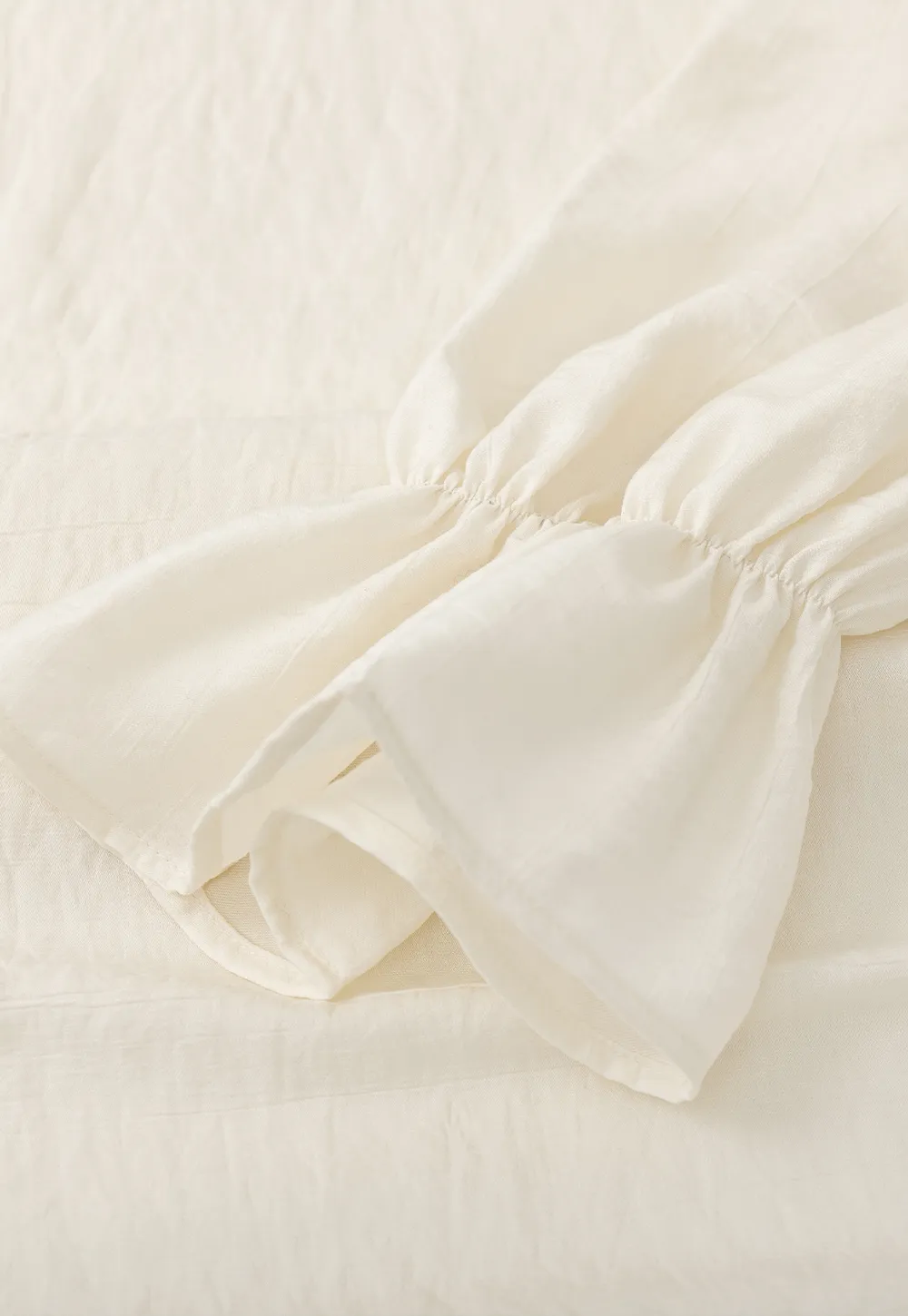 Long sleeve shirt with ruffled neckline and gathered cuffs