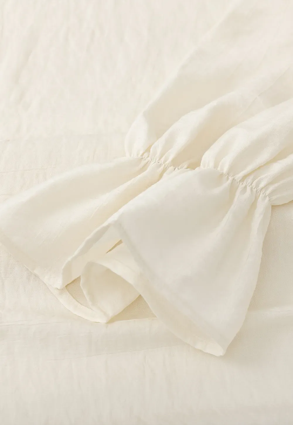 Long sleeve shirt with ruffled neckline and gathered cuffs