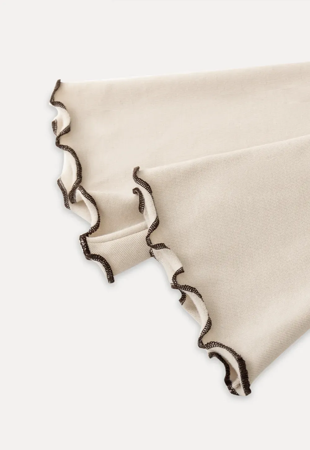 Beige Long-Sleeve Top with Ruffled Hem and Bow Tie Back