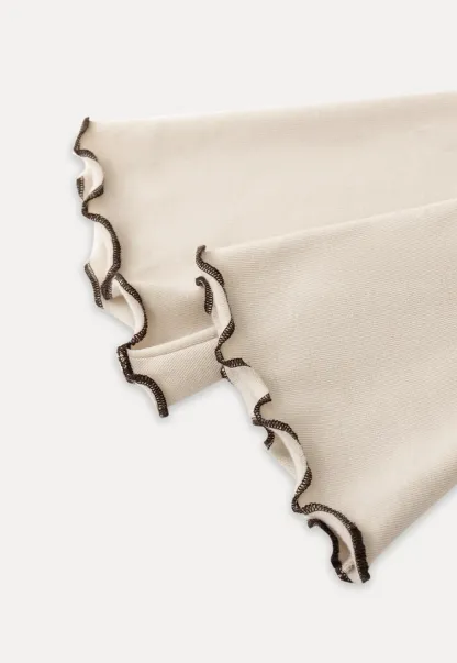 Beige Long-Sleeve Top with Ruffled Hem and Bow Tie Back