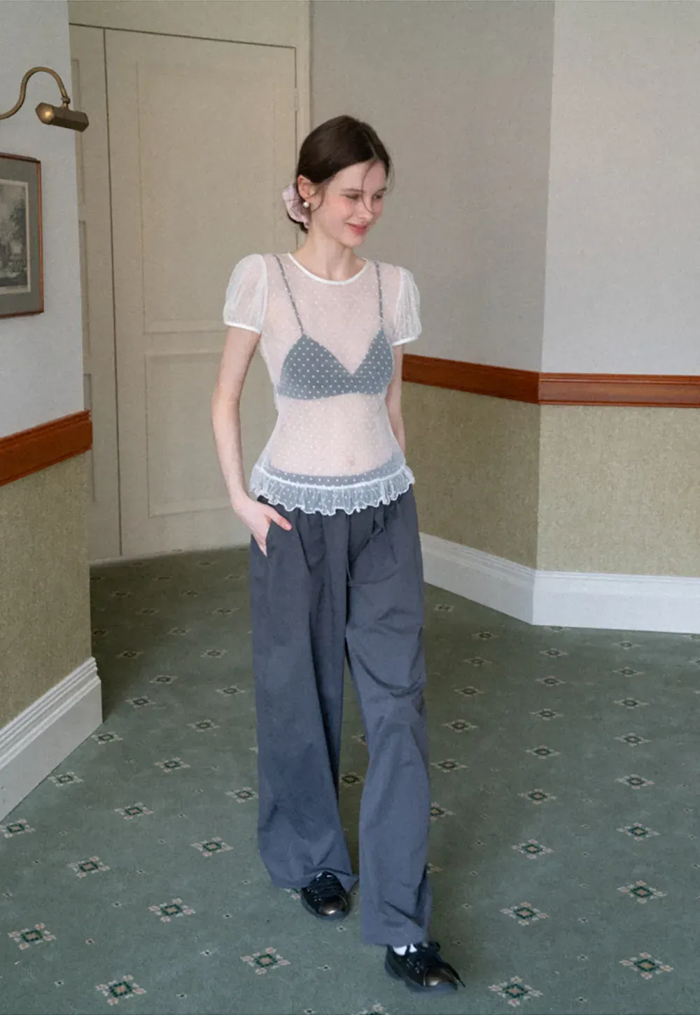 Sheer polka dot top with ruffled hem and puff sleeves