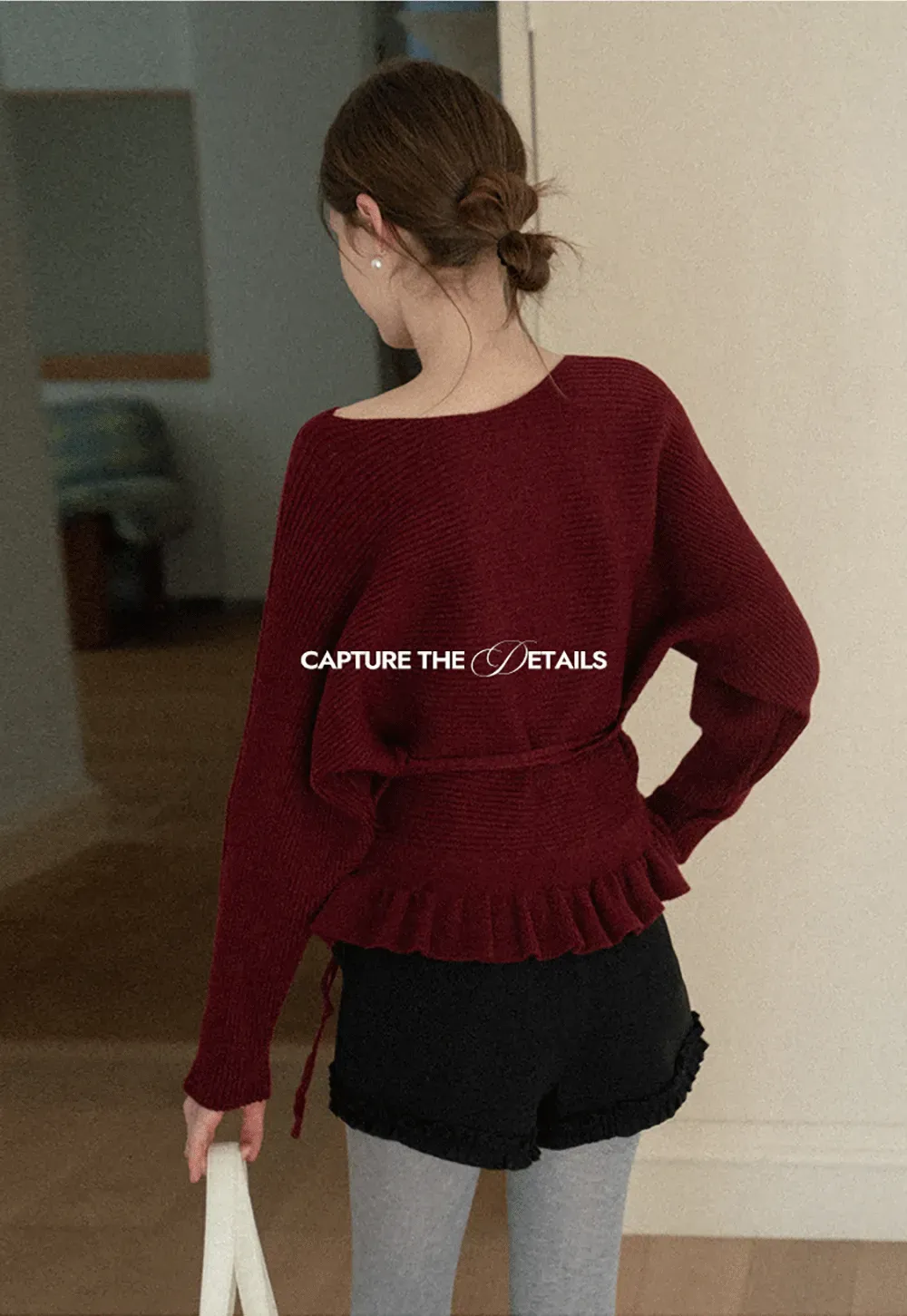 Ribbed knit sweater with tie back and flared hem design