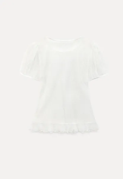 Sheer polka dot top with ruffled hem and puff sleeves