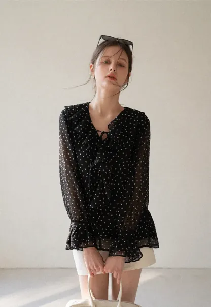 Sheer polka dot blouse with ruffled neckline and long sleeves