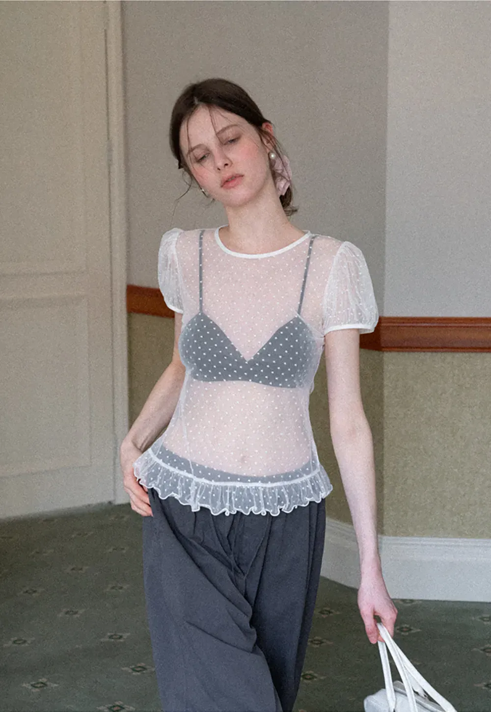 Sheer polka dot top with ruffled hem and puff sleeves