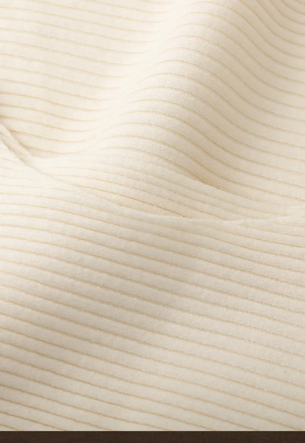 Ribbed knit sweater with tie back and flared hem design