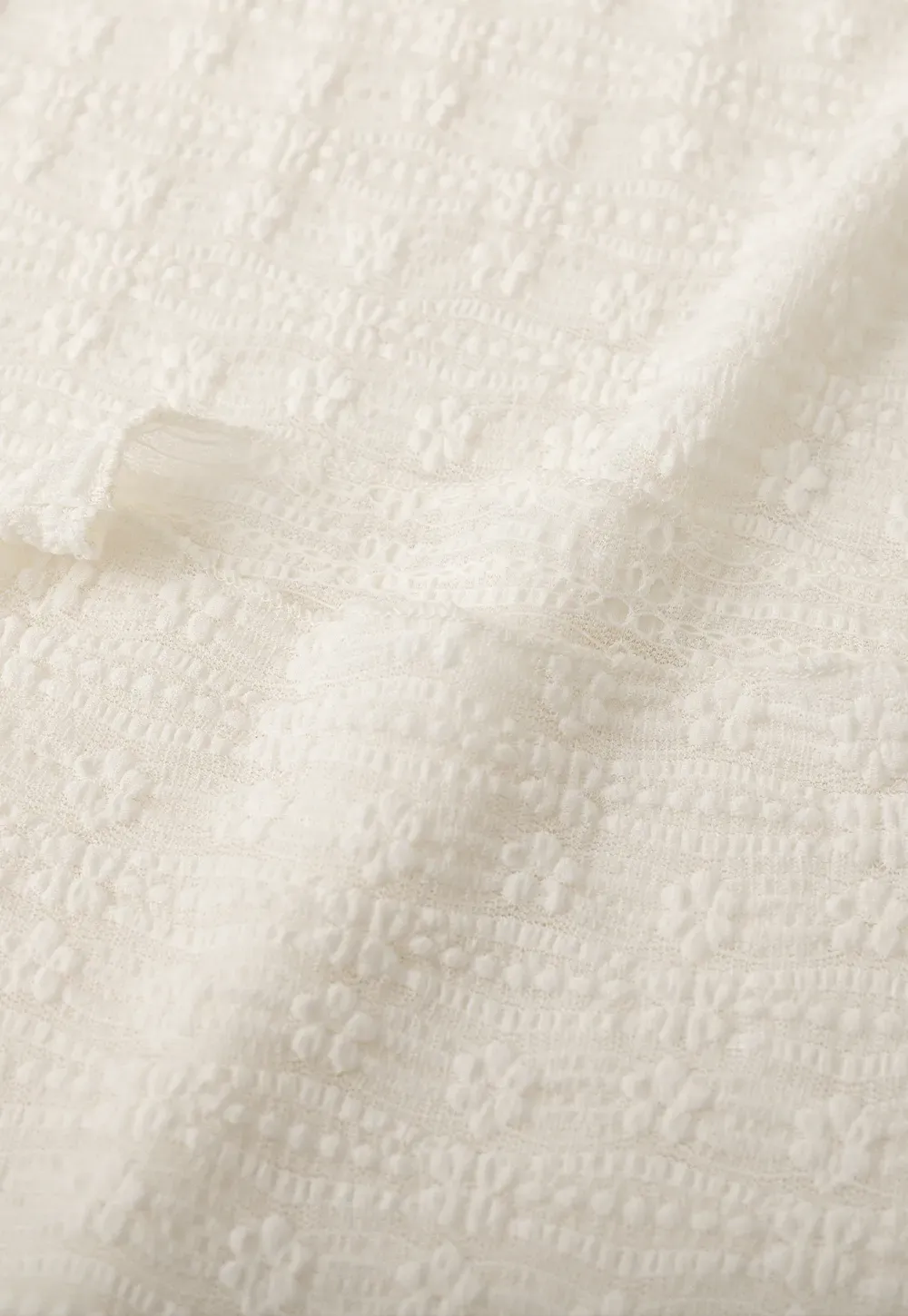 Elegant textured long sleeve top with subtle pattern design