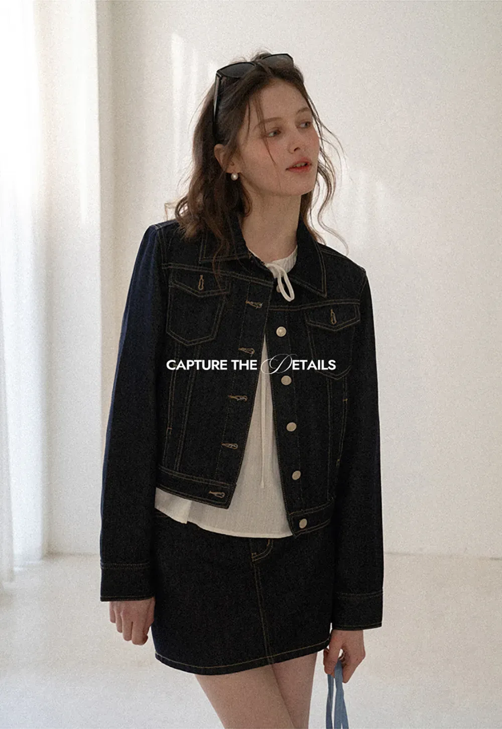 A-line denim skirt with front pocket design and adjustable waistband.