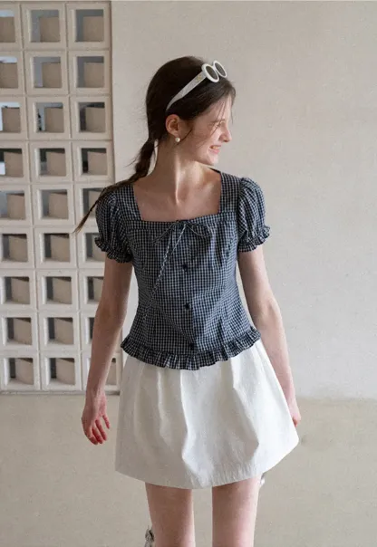 Plaid skirt with pleats and ruffled top