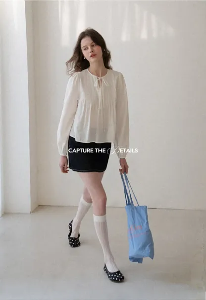 Pleated blouse with tie neck and long sleeves