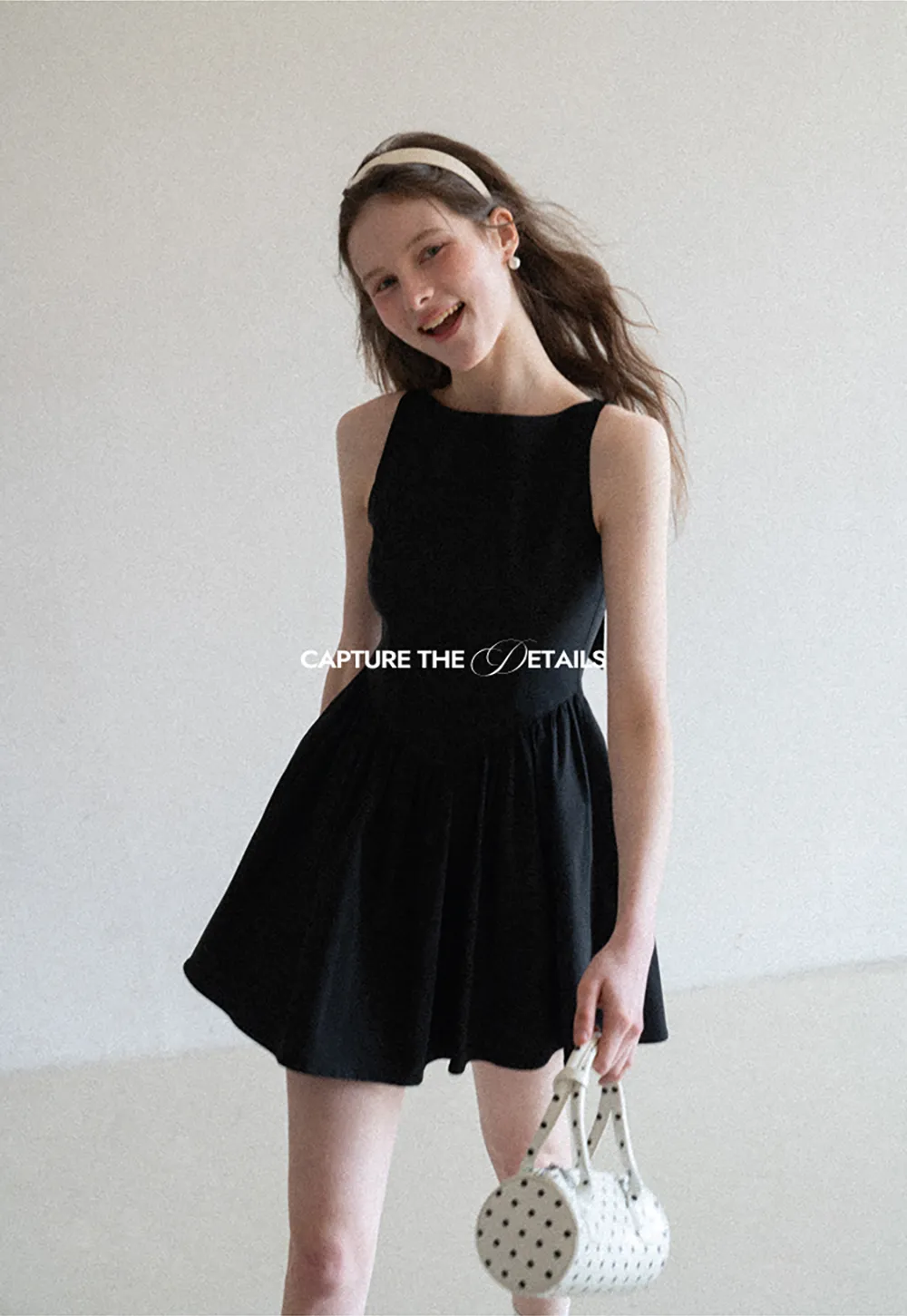 Sleeveless dress with back bow detail