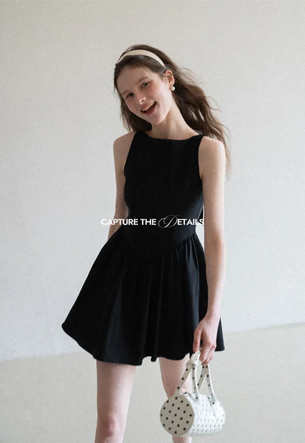 Sleeveless dress with back bow detail