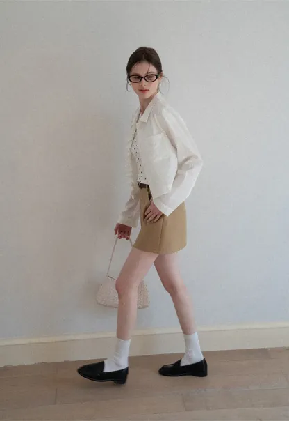 Short jacket with ruffled front placket and collar