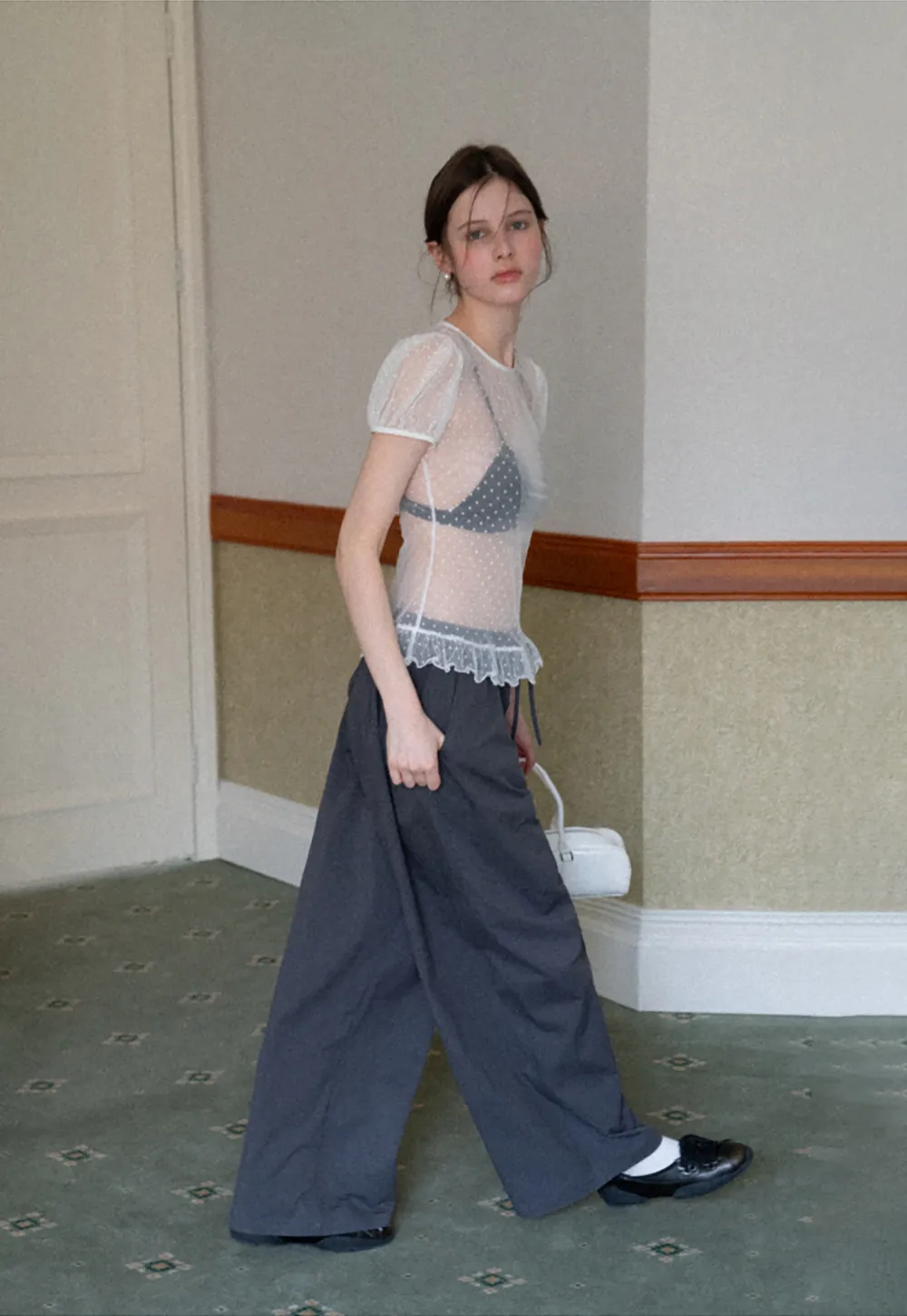 Sheer polka dot top with ruffled hem and puff sleeves