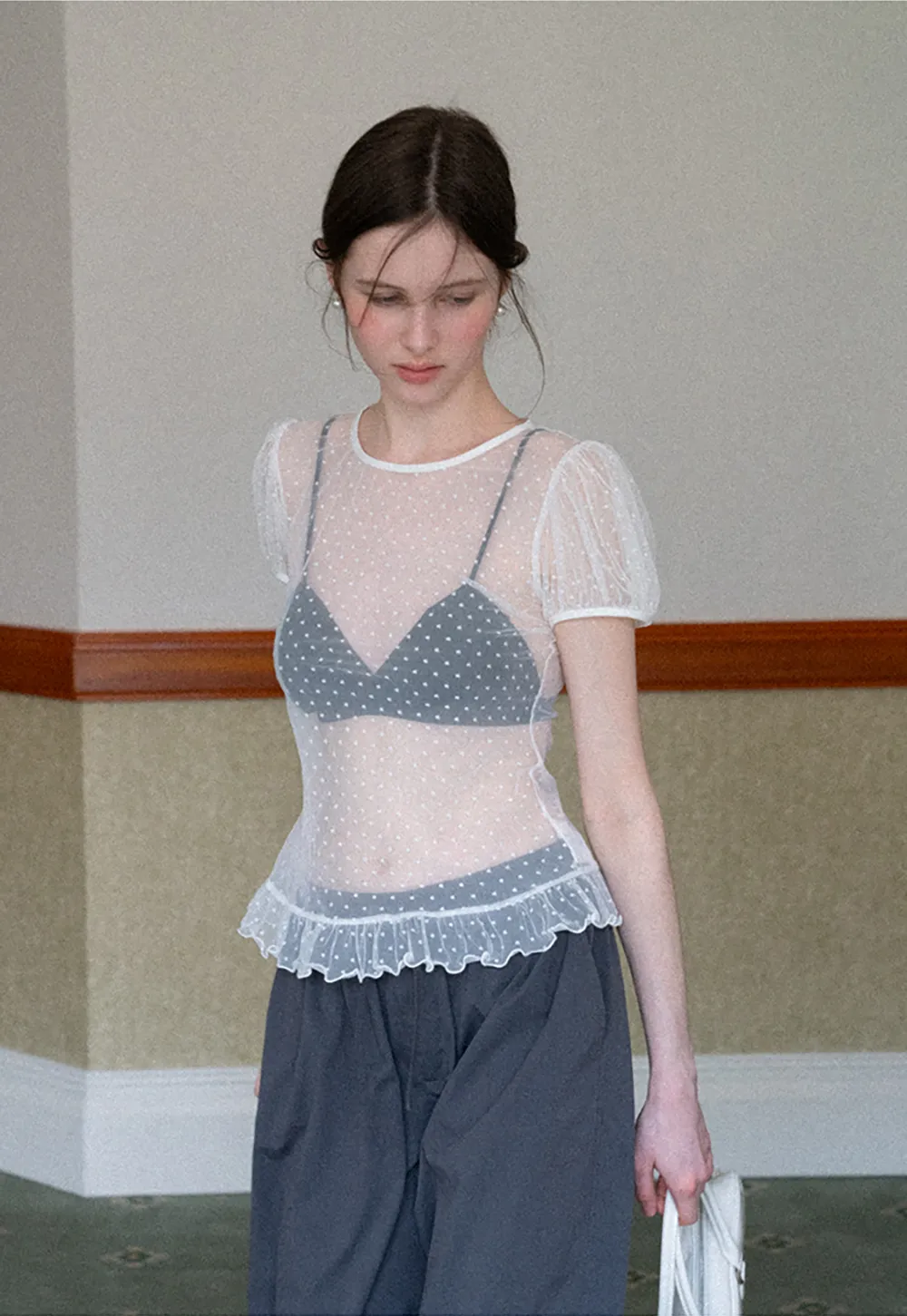 Sheer polka dot top with ruffled hem and puff sleeves