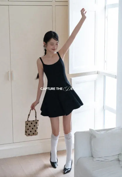 Sleeveless dress with thin straps and flared skirt