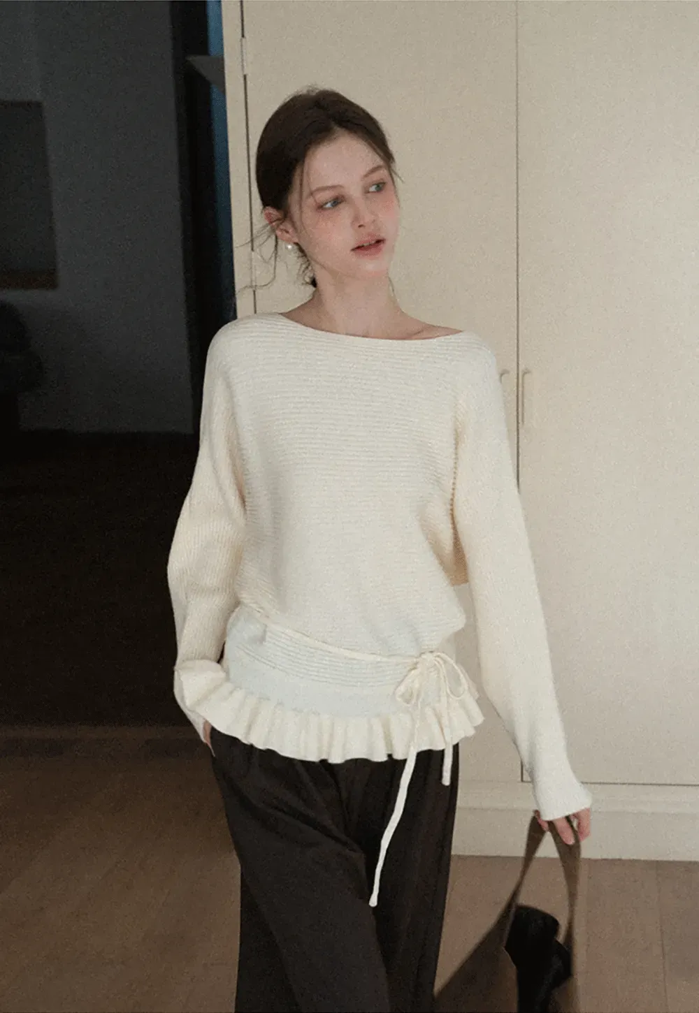 Ribbed knit sweater with tie back and flared hem design