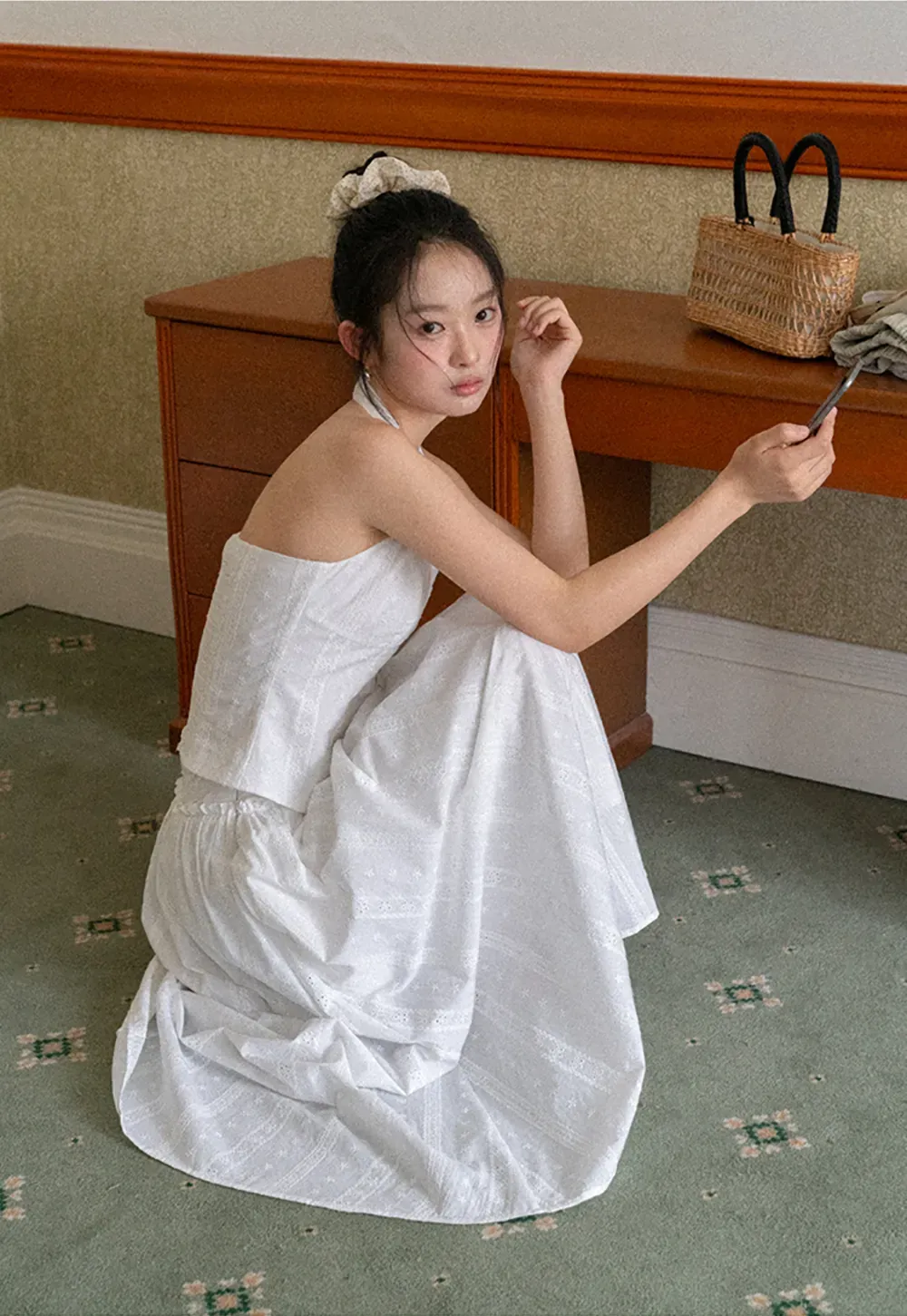 Halter neck sleeveless top with buttons and pleated skirt