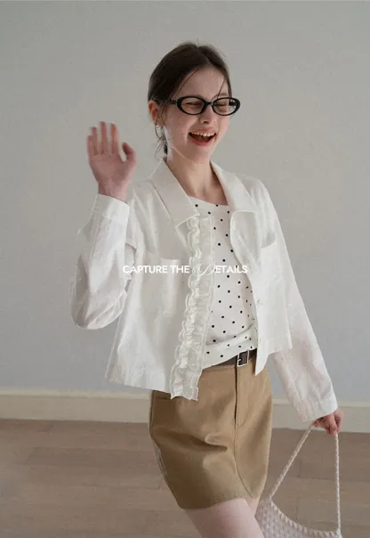 Short jacket with ruffled front placket and collar