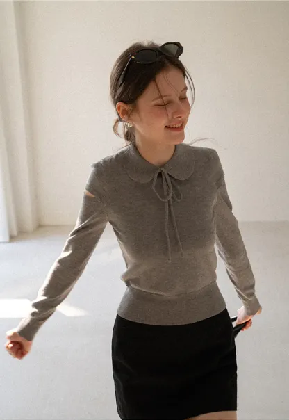 Elegant Knit Sweater with Bow Detail and Cutout Sleeves