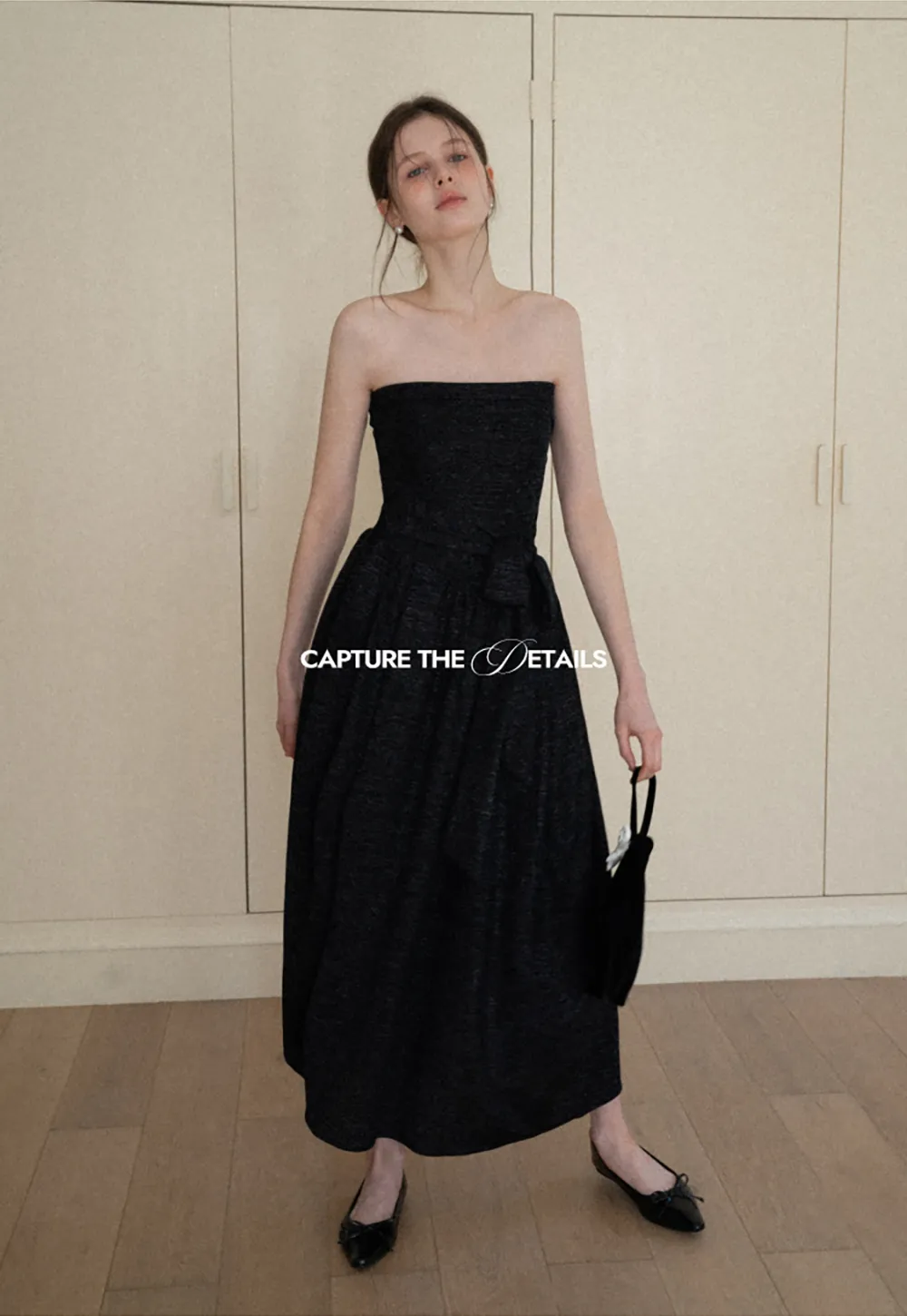 Elegant strapless midi dress with flowing skirt and textured fabric