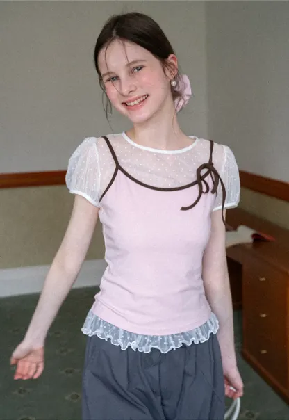 Sheer polka dot top with ruffled hem and puff sleeves