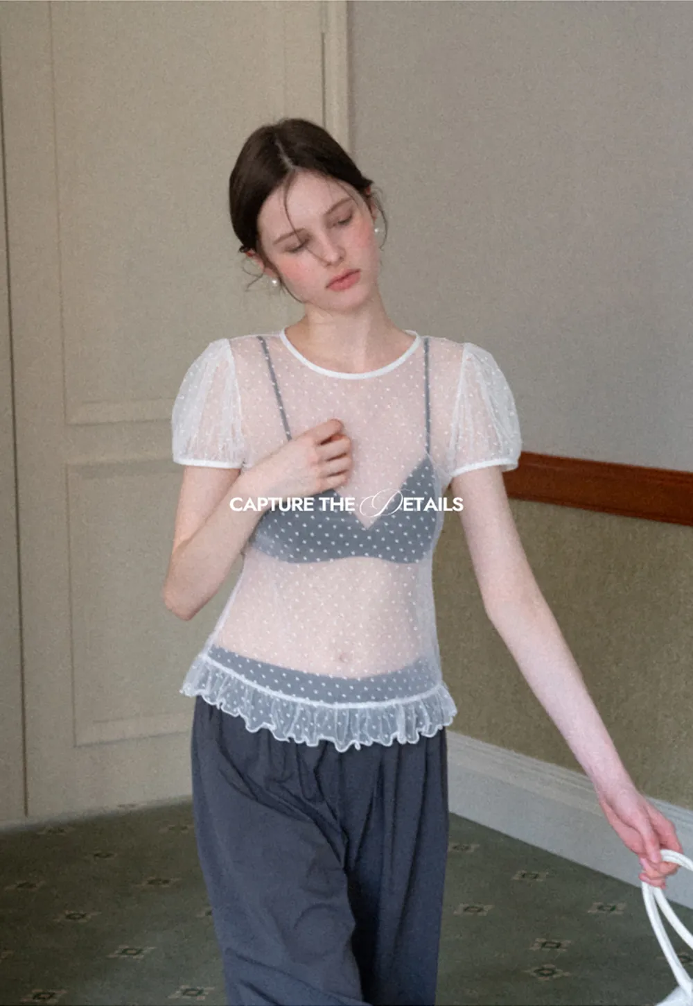 Sheer polka dot top with ruffled hem and puff sleeves