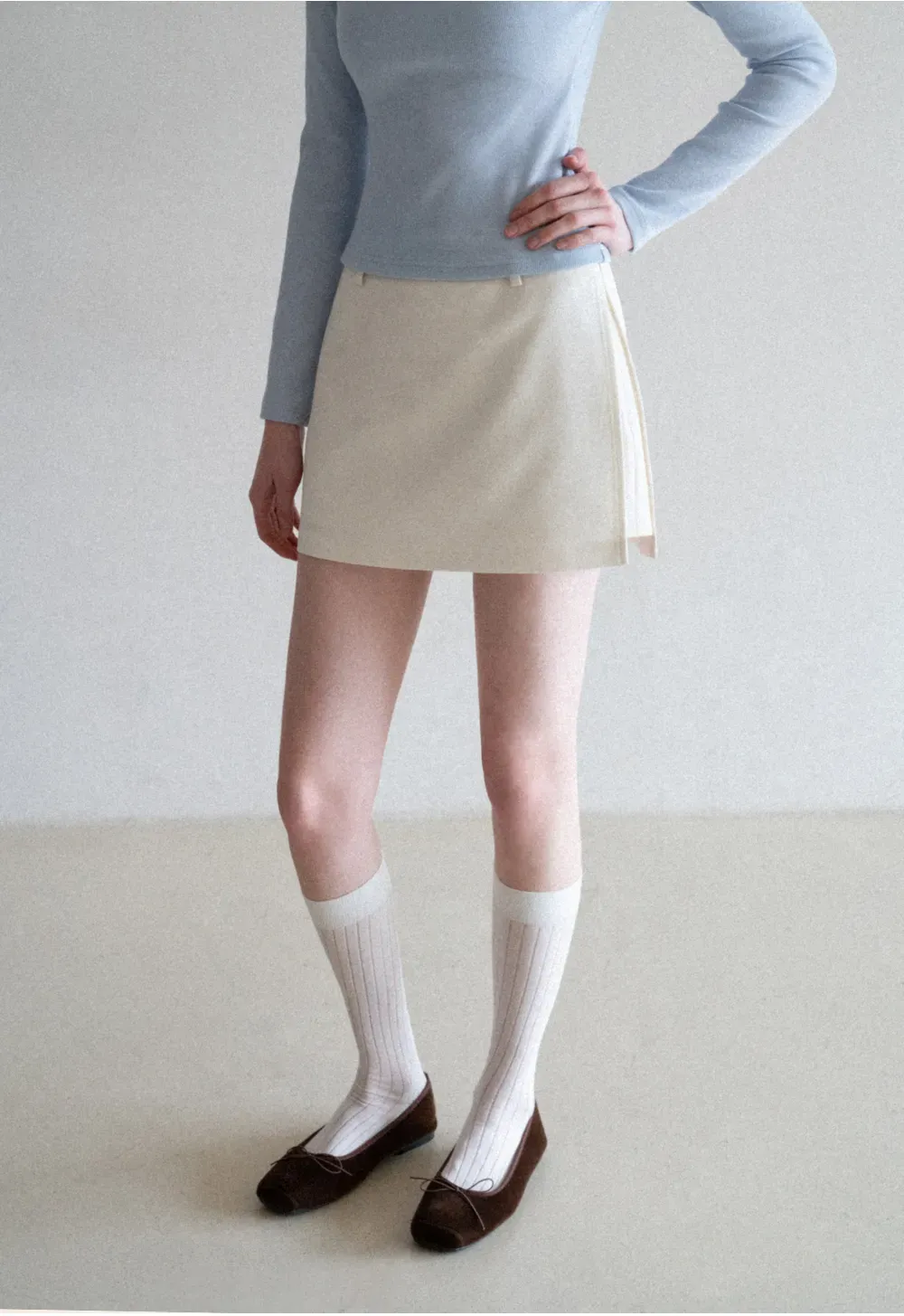 Elegant Pleated Mini Skirt with Asymmetrical Hem