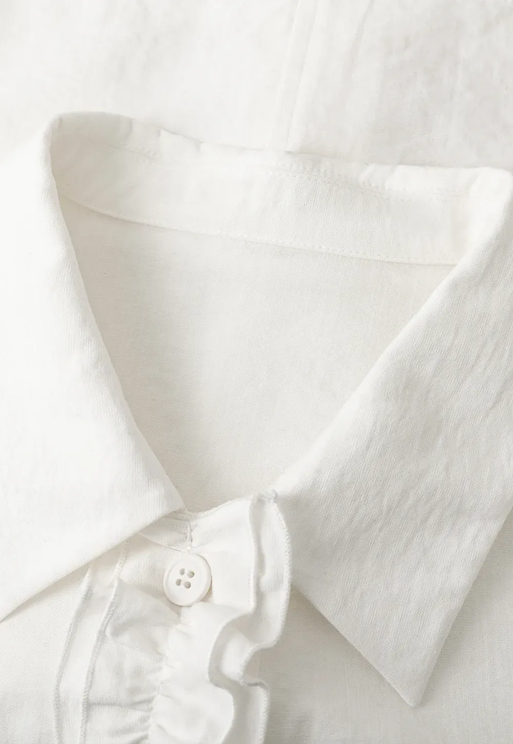 Short jacket with ruffled front placket and collar