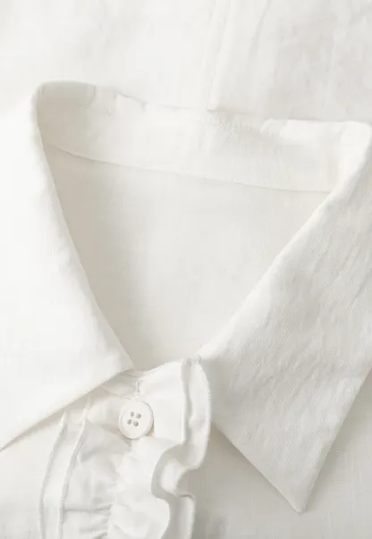 Short jacket with ruffled front placket and collar