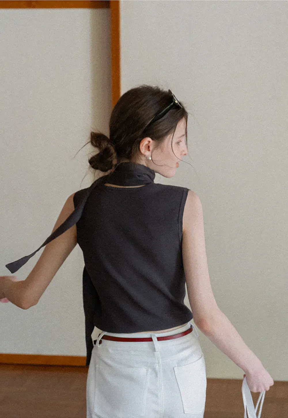 Sleeveless high neck knit top with side tie detail