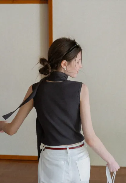 Sleeveless high neck knit top with side tie detail