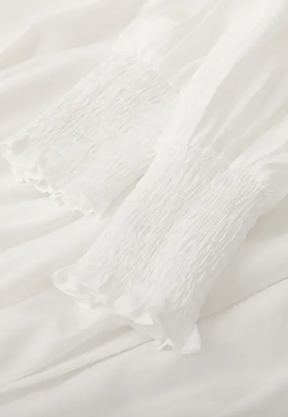 Elegant High Neck Blouse with Ruffled Cuffs and Hem