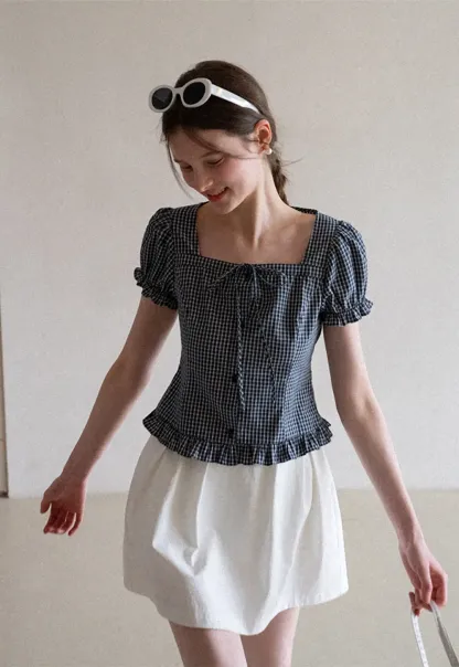 Plaid skirt with pleats and ruffled top