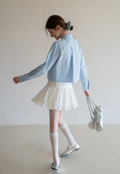 Long sleeve button front shirt with scalloped hem