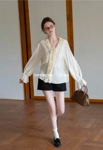 Long sleeve shirt with ruffled neckline and gathered cuffs