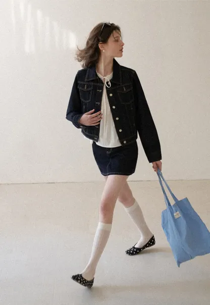 A-line denim skirt with front pocket design and adjustable waistband.