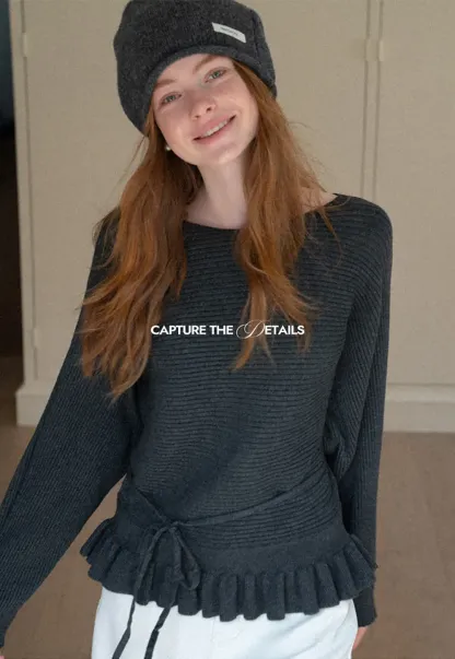 Ribbed knit sweater with tie back and flared hem design