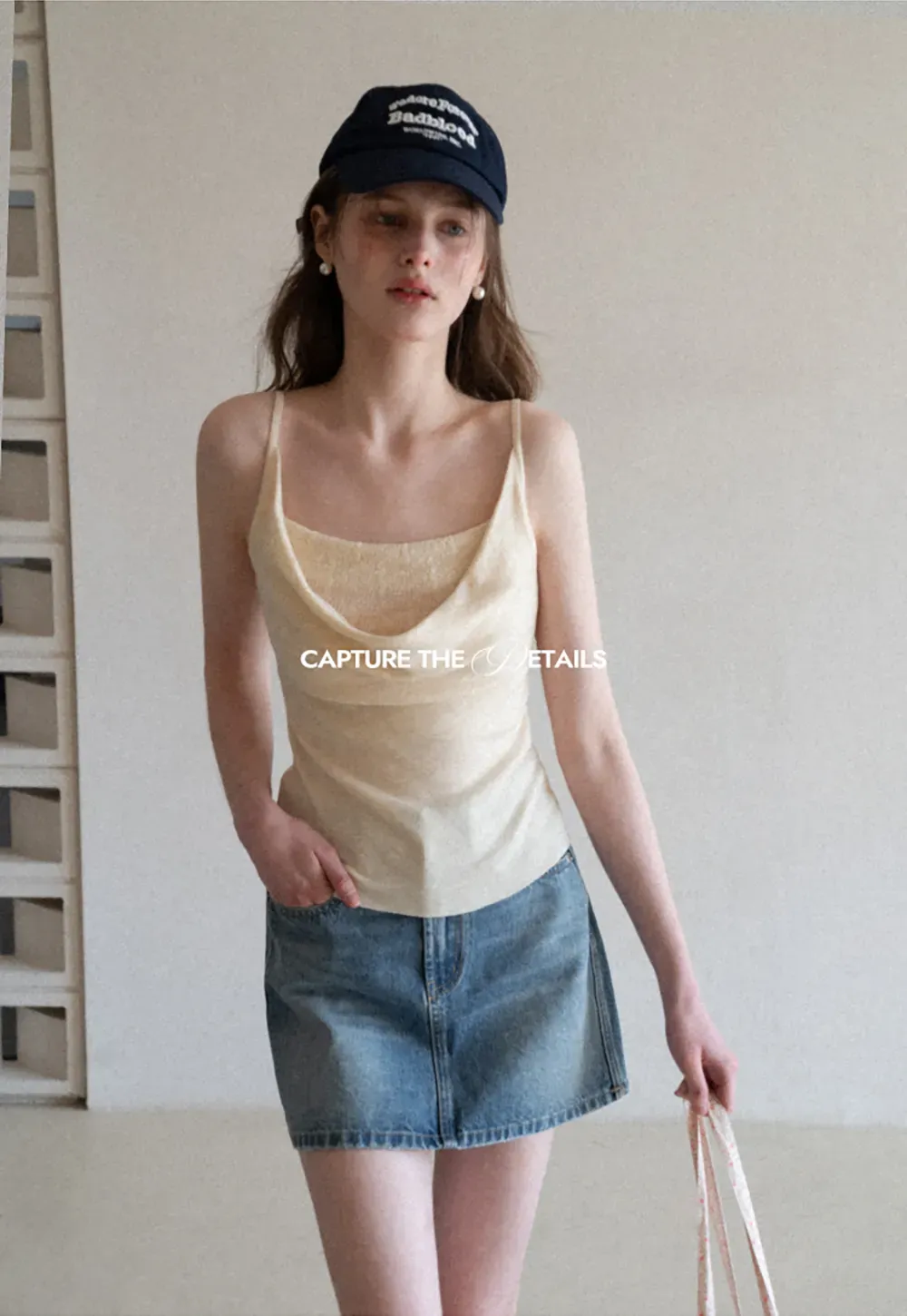 Denim mini skirt with frayed hem and front pockets