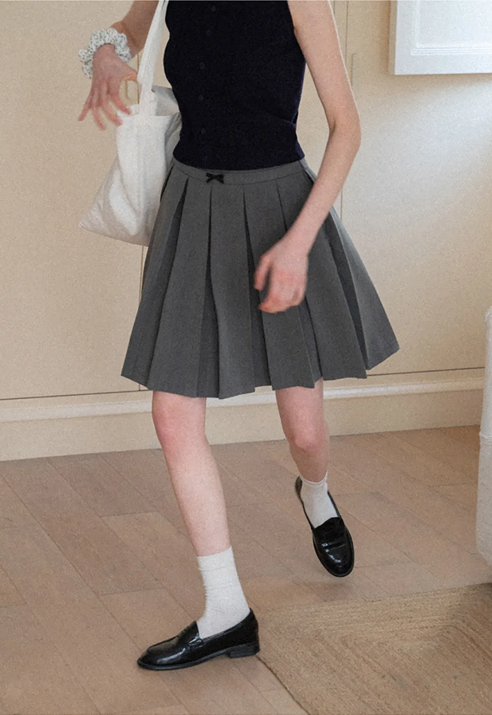 Pleated skirt with front bow detail