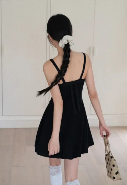 Sleeveless dress with thin straps and flared skirt