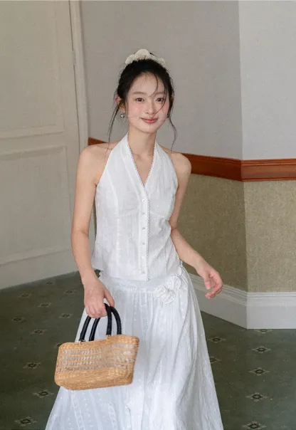 Halter neck sleeveless top with buttons and pleated skirt