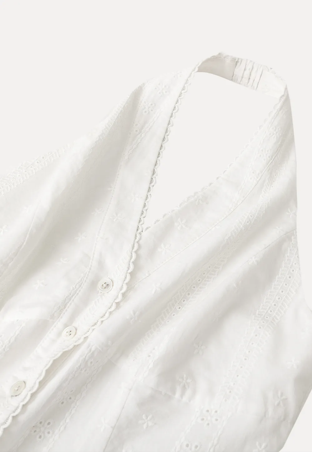 Halter neck sleeveless top with buttons and pleated skirt