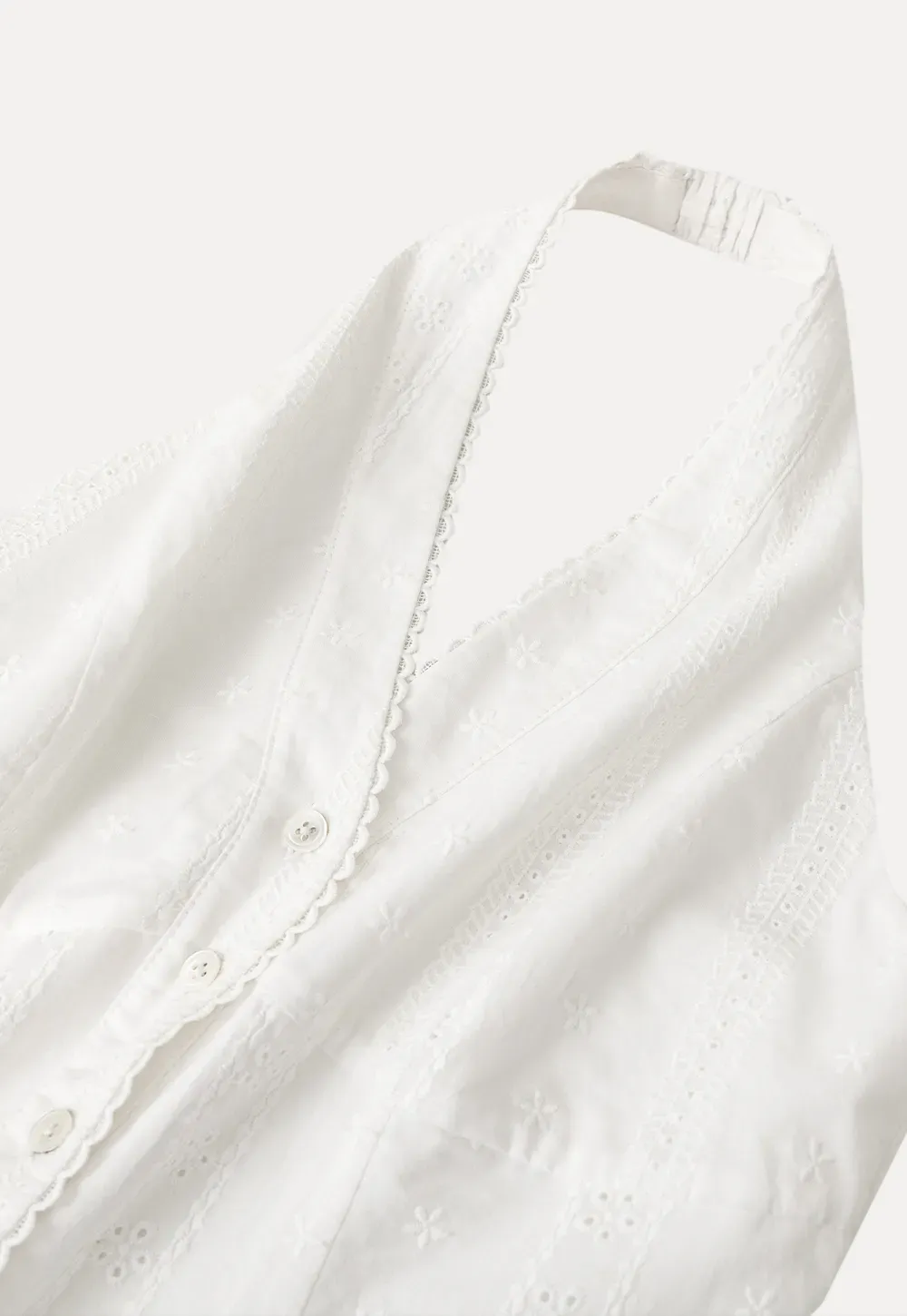 Halter neck sleeveless top with buttons and pleated skirt